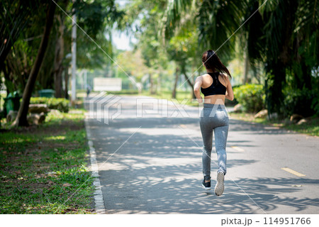 young asian woman runner athlete running at garden 114951766
