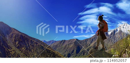 hiker standing and watching view 114952057