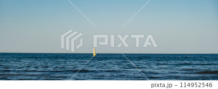 Yellow Lighthouse on blue sea line. Waves on sunny day on Baltic sea. Gdansk Poland.  114952546