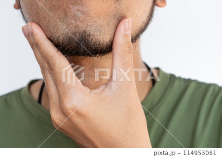 Cropped shot of Asian man touching his beard grows on a part of his lower face. Beard can make you feel more attractive. 114953081