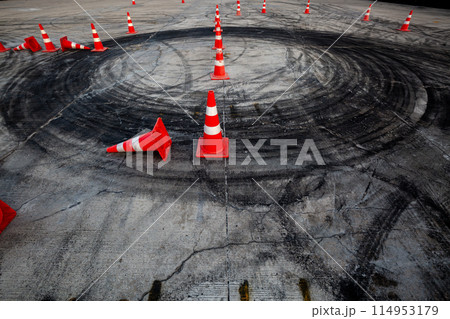 Race track road with tire mark skid road Backgroundn and traffic cone on road track, Motor sport asphalt race track and curbs with skid marks. 114953179