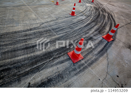 Race track road with tire mark skid road Backgroundn and traffic cone on road track, Motor sport asphalt race track and curbs with skid marks. Race track road with tire mark skid road Backgroundn and traffic cone on road track, Motor sport asphalt race track and curbs with skid marks. 114953209