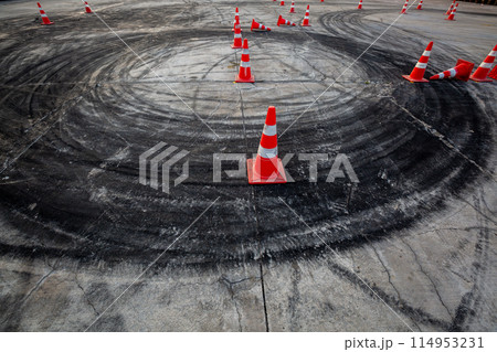 Race track road with tire mark skid road Backgroundn and traffic cone on road track, Motor sport asphalt race track and curbs with skid marks. Race track road with tire mark skid road Backgroundn and traffic cone on road track, Motor sport asphalt race track and curbs with skid marks. 114953231