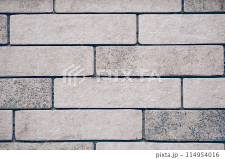 The wall is light-colored brick with space for copying. Layout for your design. High quality photo 114954016