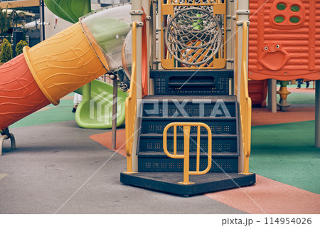 An image of a colorful playground without children. Modern slides and mazes are made of plastic. With space to copy. High quality photo An image of a colorful playground without children. Modern slides and mazes are made of plastic. With space to copy. High quality photo 114954026
