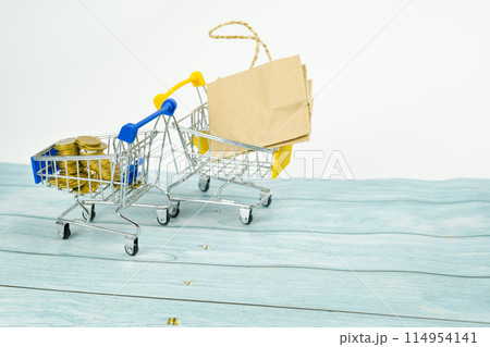 business and finance saving activity with gold coin arrange in cart with shopping acting and white isolated background business and finance saving activity with gold coin arrange in cart with shopping acting and white isolated background 114954141