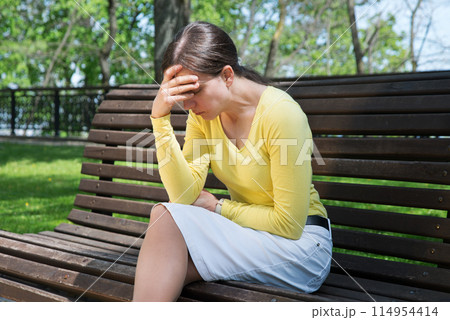 Pretty girl sitting on the bench 114954414