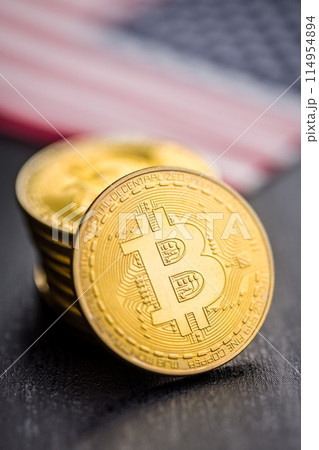 Bitcoin gold coin. Cryptocurrency with american flag on black table. 114954894