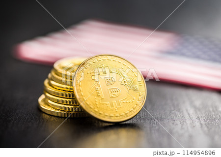 Bitcoin gold coin. Cryptocurrency with american flag on black table. 114954896
