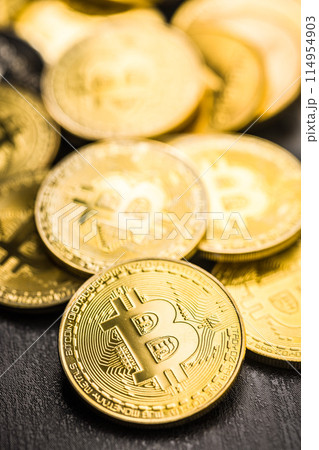 Bitcoin gold coin on black table. 114954903