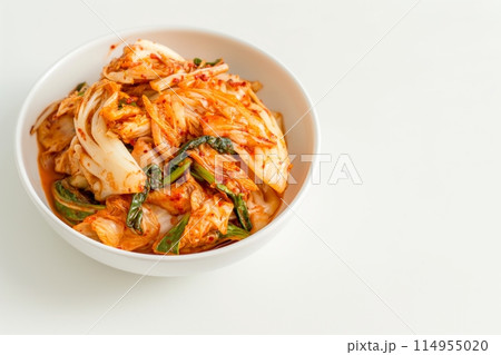 Bright bowl of kimchi on a white background with ample space 114955020