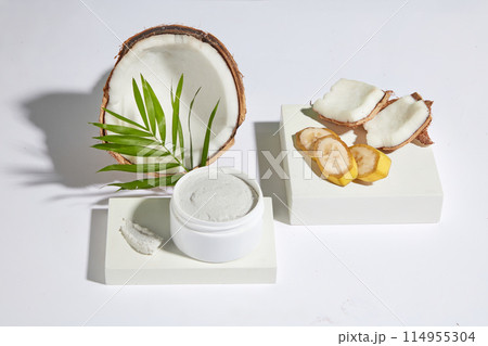 White minimalist template for design was taken from high angle shot, a blank label cosmetic jar of white cream placed on a rectangle platform. Advertising mock up for natural cosmetic with copy space 114955304