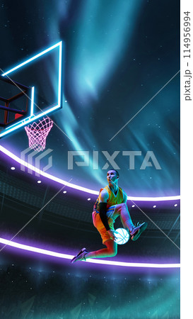 Creative image with male basketball player in motion during game, jumping in front of hoop with neon northern light colored 114956994