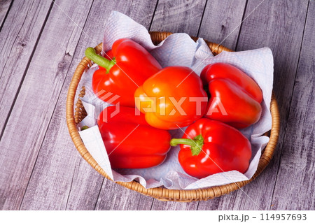redpaprikas in a wooden basket redpaprikas in a wooden basket 114957693