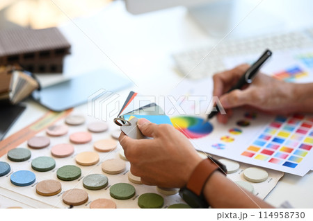 Close up Interior designer holding color samples working on new design project at office 114958730