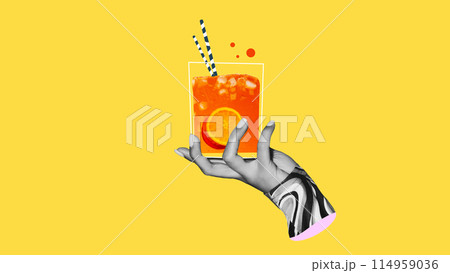 Female hand holding cool and refreshing citrus lemonade or cocktail against bright yellow background. Creative colorful design. 114959036