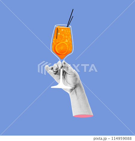 Human hand holding glass with popular refreshing drink Aperol Spritz cocktail against blue background. Creative colorful design. 114959088