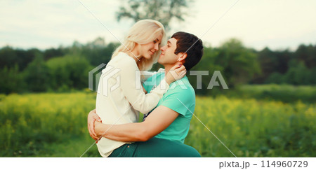 Portrait of beautiful happy smiling young couple in love together hugging in summer park 114960729