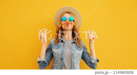 Portrait stylish funny young woman showing mustache her hair blowing lips wearing summer straw hat Portrait stylish funny young woman showing mustache her hair blowing lips wearing summer straw hat 114960808