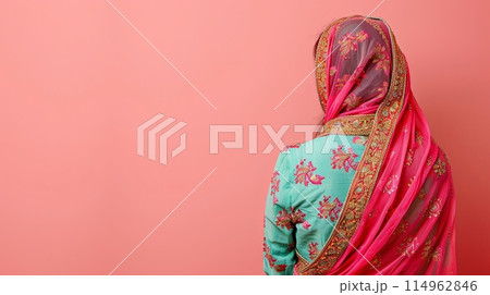 Traditional Indian women's costume dress on a pink background, copy space 114962846