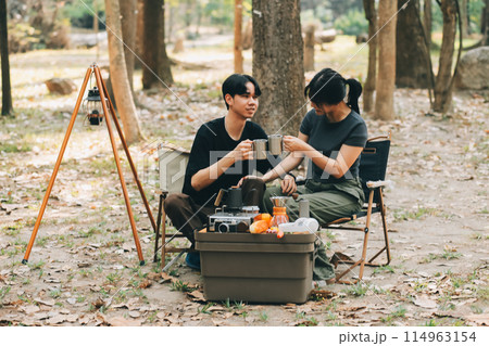 Asian couple sweet in tent inside on they camping trip, traveller relax and sleep togather in out door and camping trip Asian couple sweet in tent inside on they camping trip, traveller relax and sleep togather in out door and camping trip 114963154
