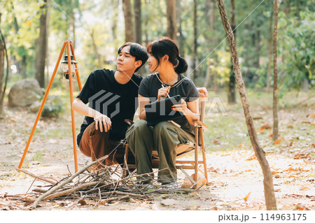 Asian couple sweet in tent inside on they camping trip, traveller relax and sleep togather in out door and camping trip Asian couple sweet in tent inside on they camping trip, traveller relax and sleep togather in out door and camping trip 114963175