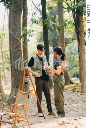 Asian couple sweet in tent inside on they camping trip, traveller relax and sleep togather in out door and camping trip Asian couple sweet in tent inside on they camping trip, traveller relax and sleep togather in out door and camping trip 114963178