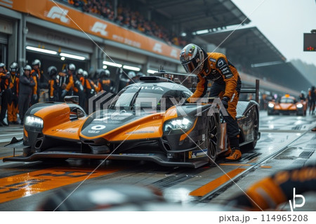 An engineer steers the car into the pit lane during a race 114965208