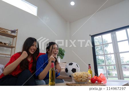 Asian lesbian couple cheering for Euro football match at home. Concept cheer and football 114967297