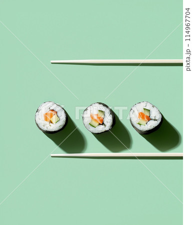 Set of sushi rolls top view over soft green background 114967704