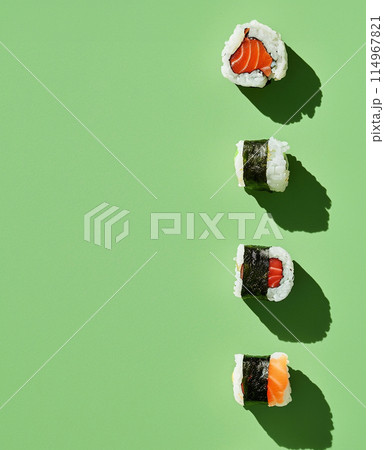Set of sushi rolls top view over soft green background 114967821