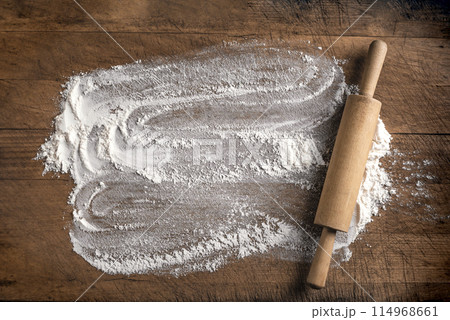 Rolling pin and flour on wooden board Rolling pin and flour on wooden board 114968661