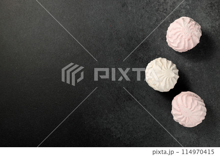 white and pink marshmallows on a black background 114970415