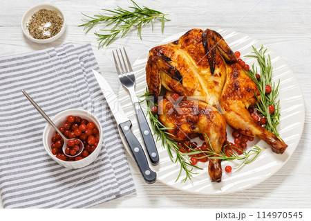 butterflied, spatchcock roast chicken on a plate 114970545
