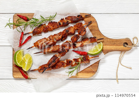 fried juicy pork kebabs on wooden cutting board fried juicy pork kebabs on wooden cutting board 114970554