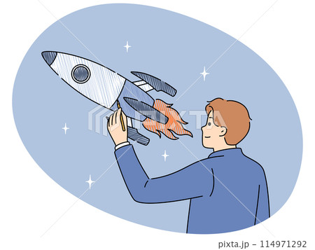 Businessman draws space rocket symbolizing successful launches and business ambitions Businessman draws space rocket symbolizing successful launches and business ambitions 114971292