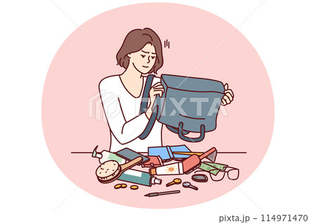 Puzzled woman shakes out contents of bag on table trying to find wallet with money or mobile phone 114971470