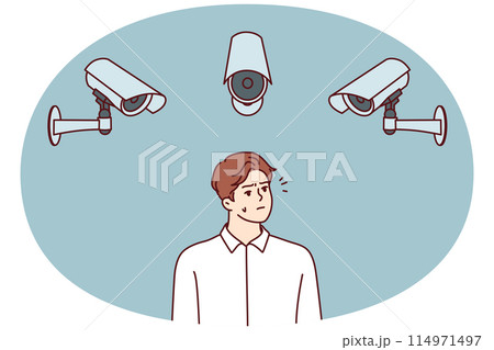 Embarrassed man standing among CCTV cameras recording every step of city dwellers Embarrassed man standing among CCTV cameras recording every step of city dwellers 114971497