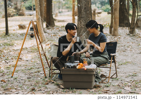 Asian couple sweet in tent inside on they camping trip, traveller relax and sleep togather in out door and camping trip Asian couple sweet in tent inside on they camping trip, traveller relax and sleep togather in out door and camping trip 114971541