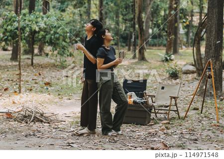 Asian couple sweet in tent inside on they camping trip, traveller relax and sleep togather in out door and camping trip Asian couple sweet in tent inside on they camping trip, traveller relax and sleep togather in out door and camping trip 114971548