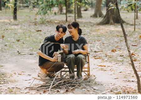 Asian couple sweet in tent inside on they camping trip, traveller relax and sleep togather in out door and camping trip Asian couple sweet in tent inside on they camping trip, traveller relax and sleep togather in out door and camping trip 114971560