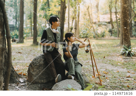 Asian couple sweet in tent inside on they camping trip, traveller relax and sleep togather in out door and camping trip Asian couple sweet in tent inside on they camping trip, traveller relax and sleep togather in out door and camping trip 114971616