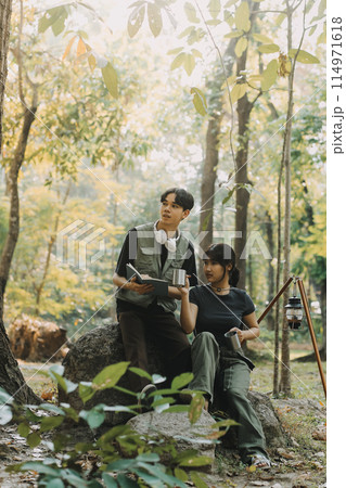 Asian couple sweet in tent inside on they camping trip, traveller relax and sleep togather in out door and camping trip Asian couple sweet in tent inside on they camping trip, traveller relax and sleep togather in out door and camping trip 114971618