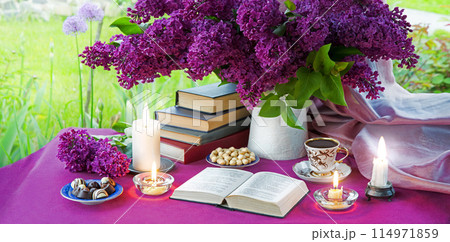Antique still life with a bouquet of lilacs, coffee, books and candles 114971859