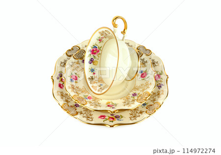 Vintage porcelain cups and saucer isolated on white . Vintage porcelain cups and saucer isolated on white . 114972274