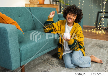 Saving money investment for future. African American girl holding pink piggy bank and putting money coin. Saving investment budget business wealth retirement financial money banking concept 114972596
