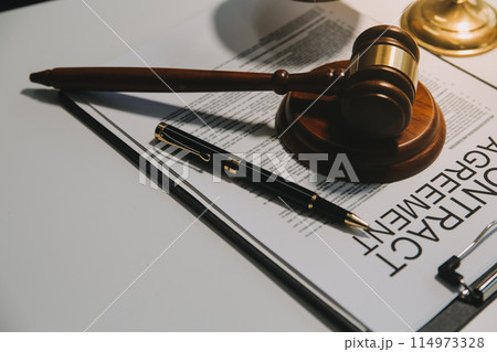 Lawyer, legal advisor, businessman brainstorming information on agreement details Business contracts in legal processing books for accuracy in contract documents. joint financial investment. 114973328
