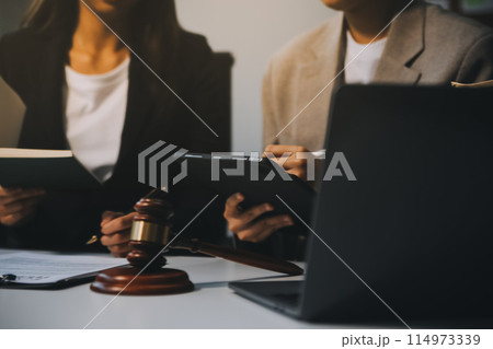 Lawyer, legal advisor, businessman brainstorming information on agreement details Business contracts in legal processing books for accuracy in contract documents. joint financial investment. 114973339