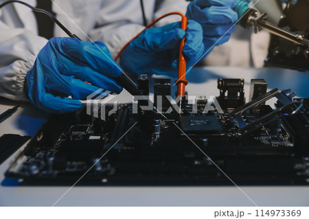 Close up of Technician measuring voltage electronic circuit board television, Service after sale fix electric equipment within insurance. Close up of Technician measuring voltage electronic circuit board television, Service after sale fix electric equipment within insurance. 114973369