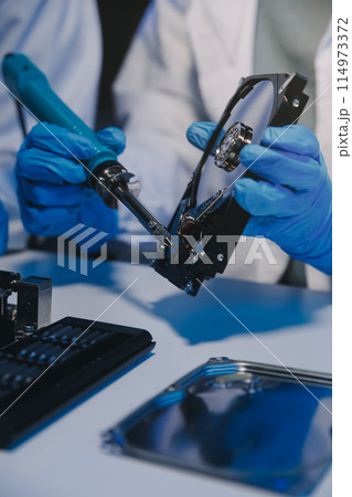 Close up of Technician measuring voltage electronic circuit board television, Service after sale fix electric equipment within insurance. 114973372